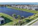 Scenic aerial view of homes lining a peaceful lake, showcasing the community layout and landscaping at 17902 Cherished Loop, Lakewood Ranch, FL 34211