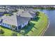 Aerial view of lakeside homes with manicured lawns, tile roofs, and community landscaping at 17902 Cherished Loop, Lakewood Ranch, FL 34211