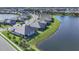 Panoramic aerial view of lakeside homes in a Primary-planned community, highlighting the waterfront property at 17902 Cherished Loop, Lakewood Ranch, FL 34211