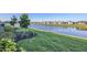 Backyard featuring lush green grass leading to a tranquil lake at 17902 Cherished Loop, Lakewood Ranch, FL 34211