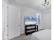 Neat bedroom with a view of a television, gray carpet, and closet with sliding doors at 17902 Cherished Loop, Lakewood Ranch, FL 34211