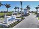 Elegant gated community entrance with lush landscaping and a welcoming sign at 17902 Cherished Loop, Lakewood Ranch, FL 34211