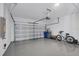 Spacious garage with epoxy flooring, ample storage, and a modern garage door at 17902 Cherished Loop, Lakewood Ranch, FL 34211