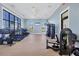 A spacious gym area equipped with treadmills, weight machines, and large windows for natural light at 17902 Cherished Loop, Lakewood Ranch, FL 34211