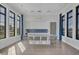 Modern kitchen features sleek white cabinetry, a center island with seating, and blue backsplash at 17902 Cherished Loop, Lakewood Ranch, FL 34211