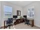Bright office space featuring dual desks, neutral walls, and natural light from large windows at 17902 Cherished Loop, Lakewood Ranch, FL 34211