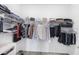 Well-organized walk-in closet with shelves, hanging rods, and stylish handbags displayed at 17902 Cherished Loop, Lakewood Ranch, FL 34211
