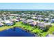 Aerial view of homes in a beautiful lakeside community, with lush green lawns and mature trees at 1806 85Th Nw Ct, Bradenton, FL 34209