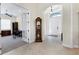 Open foyer with tile flooring, flowing into an office space with neutral carpet and views of the home's front entrance at 1806 85Th Nw Ct, Bradenton, FL 34209
