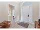 Bright foyer featuring tile flooring, neutral walls, and an elegant front door at 1806 85Th Nw Ct, Bradenton, FL 34209