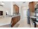 Modern kitchen with stainless steel appliances, granite countertops, and ample cabinet space, leading to dining room at 1806 85Th Nw Ct, Bradenton, FL 34209