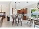Open-concept kitchen features a breakfast bar, stainless steel appliances, and wood cabinetry at 1806 85Th Nw Ct, Bradenton, FL 34209