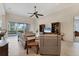 Bright living room featuring neutral furniture, tile flooring, ceiling fan, and access to the outdoor patio at 1806 85Th Nw Ct, Bradenton, FL 34209