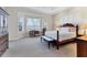 Spacious main bedroom featuring a tray ceiling, sitting area, and large windows that provide plenty of natural light at 1806 85Th Nw Ct, Bradenton, FL 34209