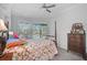 Cozy bedroom with natural light and view of the pool at 2183 Muskogee Trl, Nokomis, FL 34275