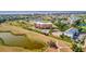 Aerial view of the community featuring a pool, tennis courts, waterways, and manicured landscaping at 2311 14Th W Ave # 208, Palmetto, FL 34221