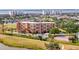 Community aerial view showcases the pool, tennis courts, lush greenery, and well-maintained grounds at 2311 14Th W Ave # 208, Palmetto, FL 34221