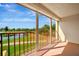 Balcony view overlooking a lake, golf course, and lush landscaping, creating a serene outdoor space at 2311 14Th W Ave # 208, Palmetto, FL 34221