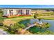 Condominium building overlooking a serene pond with gazebo and meticulously maintained green spaces at 2311 14Th W Ave # 208, Palmetto, FL 34221