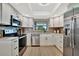 Updated kitchen featuring stainless appliances, granite countertops, and white cabinetry at 2311 14Th W Ave # 208, Palmetto, FL 34221
