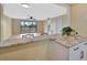Open living room with a ceiling fan and sliding doors to a balcony with a water view at 2311 14Th W Ave # 208, Palmetto, FL 34221