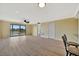Spacious living room with ceiling fan, sliding doors to a balcony, and view of the lake at 2311 14Th W Ave # 208, Palmetto, FL 34221