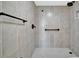 Tiled walk-in shower with bronze fixtures and river rock flooring at 2311 14Th W Ave # 208, Palmetto, FL 34221