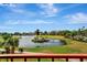 Scenic view of a pond featuring a gazebo, wooden bridge and manicured greenery at 2311 14Th W Ave # 208, Palmetto, FL 34221