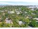 A scenic aerial view of a neighborhood with lush greenery and beautiful homes with cityscape at 2315 Mcclellan Pkwy, Sarasota, FL 34239