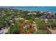 Enchanting aerial view of a tree-lined neighborhood with glimpses of a charming home and the expansive bay in the background at 2315 Mcclellan Pkwy, Sarasota, FL 34239