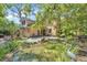 Private backyard with a charming pond, lush landscaping, and artistic décor at 2315 Mcclellan Pkwy, Sarasota, FL 34239