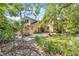 Landscaped backyard with a charming outdoor sitting area at 2315 Mcclellan Pkwy, Sarasota, FL 34239