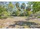 A spacious backyard perfect for outdoor gatherings, featuring scattered plants and a charming bench at 2315 Mcclellan Pkwy, Sarasota, FL 34239