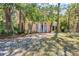Home's exterior featuring a turquoise front door, white columns, a balcony, and natural landscaping at 2315 Mcclellan Pkwy, Sarasota, FL 34239