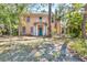 Charming two-story home featuring a turquoise front door, white columns, and a quaint second-story balcony at 2315 Mcclellan Pkwy, Sarasota, FL 34239