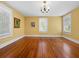 Bright living room features hardwood floors, white trim, and an antique chandelier at 2315 Mcclellan Pkwy, Sarasota, FL 34239