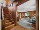 Inviting living room featuring hardwood floors, wood paneling, and an open staircase at 2315 Mcclellan Pkwy, Sarasota, FL 34239