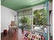 Cozy sunroom with terra cotta tile, and large windows that open onto the garden at 2315 Mcclellan Pkwy, Sarasota, FL 34239
