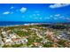 Beautiful aerial view showcasing the city, residential homes, lush trees, and an ocean backdrop at 236 Harbor S Dr # 205, Venice, FL 34285