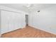 Bedroom with closet, ceiling fan, and wood floors at 236 Harbor S Dr # 205, Venice, FL 34285