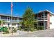 Two-story condo building featuring a well maintained garden, exterior stairs and a screened balcony at 236 Harbor S Dr # 205, Venice, FL 34285
