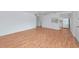 Bright, open-concept living room with hardwood floors and a pass-through to the all-white kitchen at 236 Harbor S Dr # 205, Venice, FL 34285