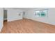 Bright living room with hardwood floors, neutral walls, and a pass-through to the kitchen at 236 Harbor S Dr # 205, Venice, FL 34285