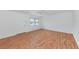 Spacious living room with hardwood floors, a bright window, and neutral walls at 236 Harbor S Dr # 205, Venice, FL 34285