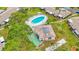 Aerial shot of villas, featuring a community pool, green space, landscaping, and outdoor recreation areas at 2802 Swifton Dr # V102, Sarasota, FL 34231