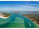 Breathtaking aerial view of Intercoastal waterways with vibrant turquoise waters on a sunny day with a boat cruising the water at 2802 Swifton Dr # V102, Sarasota, FL 34231