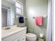 Well-lit bathroom with a vanity, sink, toilet, and shower with curtain at 2802 Swifton Dr # V102, Sarasota, FL 34231