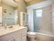 Clean bathroom with a vanity, toilet, tub, and shower featuring bright, natural light at 2802 Swifton Dr # V102, Sarasota, FL 34231