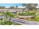 Inviting aerial shot of the villa's entrance sign with manicured landscaping and tropical palm trees at 2802 Swifton Dr # V102, Sarasota, FL 34231
