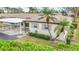 Charming single-story home featuring lush landscaping, covered parking, and a well-maintained exterior at 2802 Swifton Dr # V102, Sarasota, FL 34231